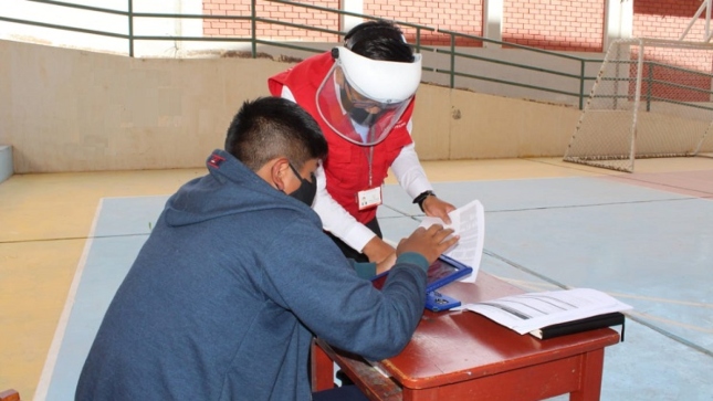 Imagen JPG de colaborador de la Contraloría orientando a un ciudadanos en el marco de la supervisión de tablets en zonas rurales de Moquegua.