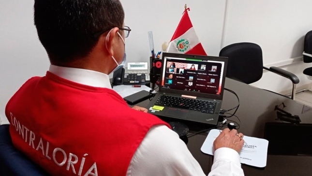 Imagen JPG de colaborador de la Contraloría sentado en su escritorio participando en la audiencia pública virtual “La Contraloría te Escucha” Pasco.
