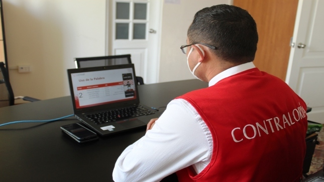 Imagen JPG de colaborador de la Contraloría sentado en su escritorio con su laptop participando en la Audiencia Pública virtual en Asunción, Áncash.