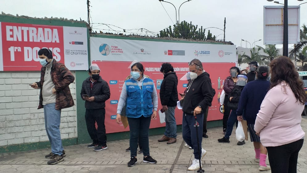 Foto de personas haciendo fila para ingresar a vacunatorio