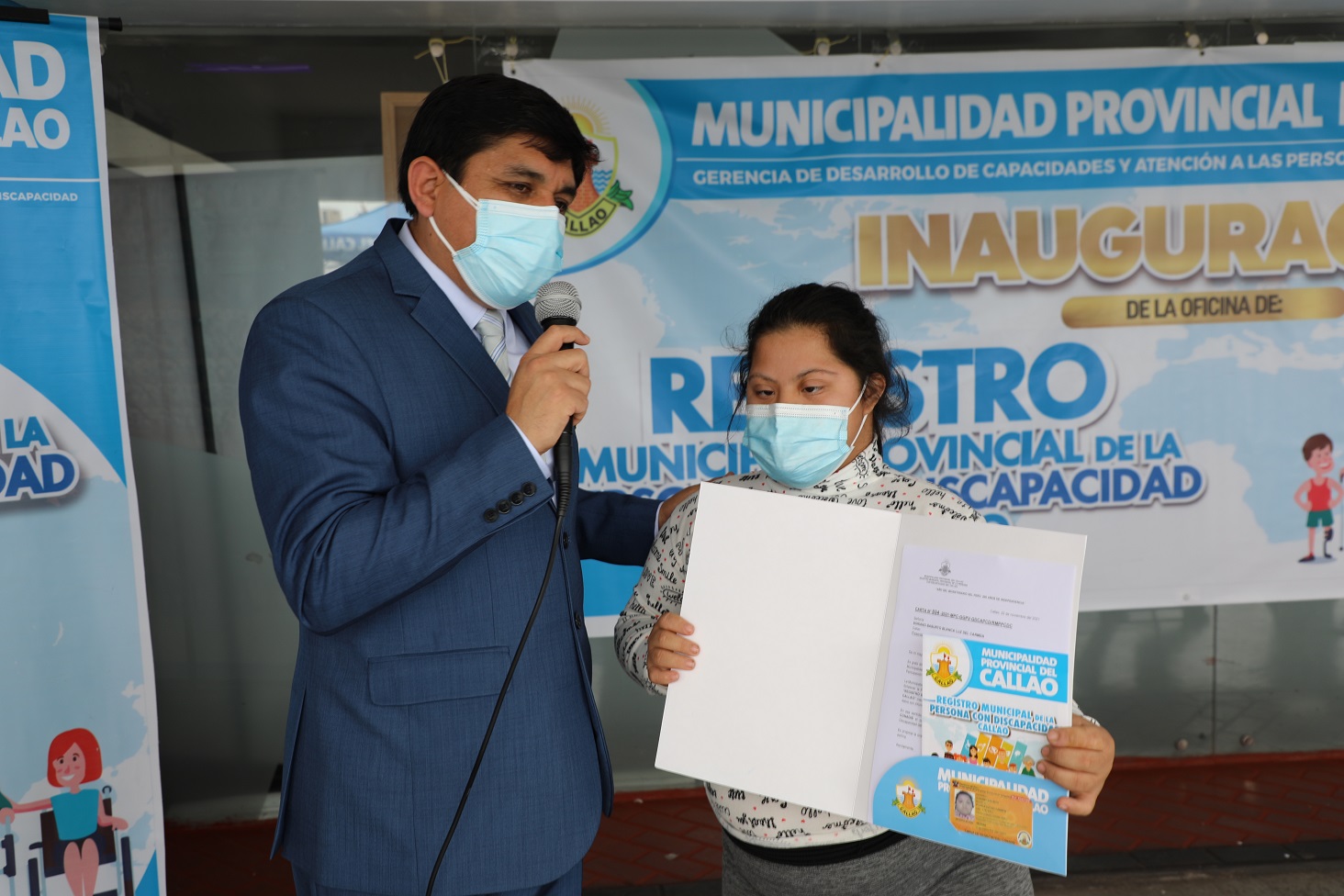 Sandro Caller , responsable de la OMAPED entrega un carnet amarillo a una usuaria con discapacidad intelectual (Síndrome de Down)