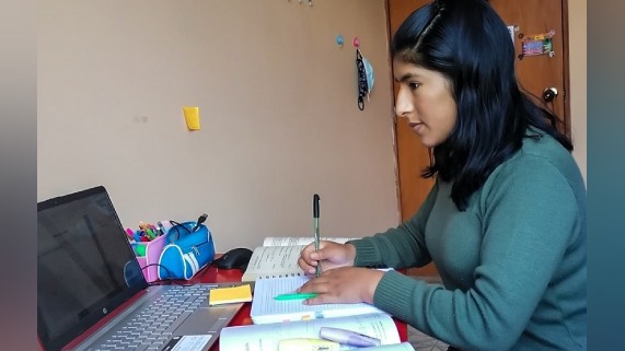 Estudiante frente a su mesa de estudios