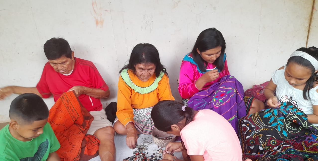 Rosa junto a su familia elaborando artesanía