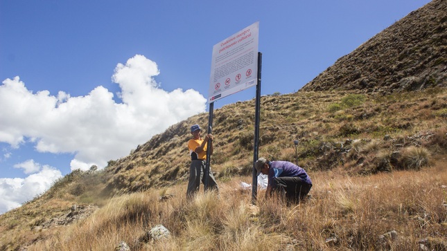 Vecinos de Cerro Piogán instalando paneles informativos.