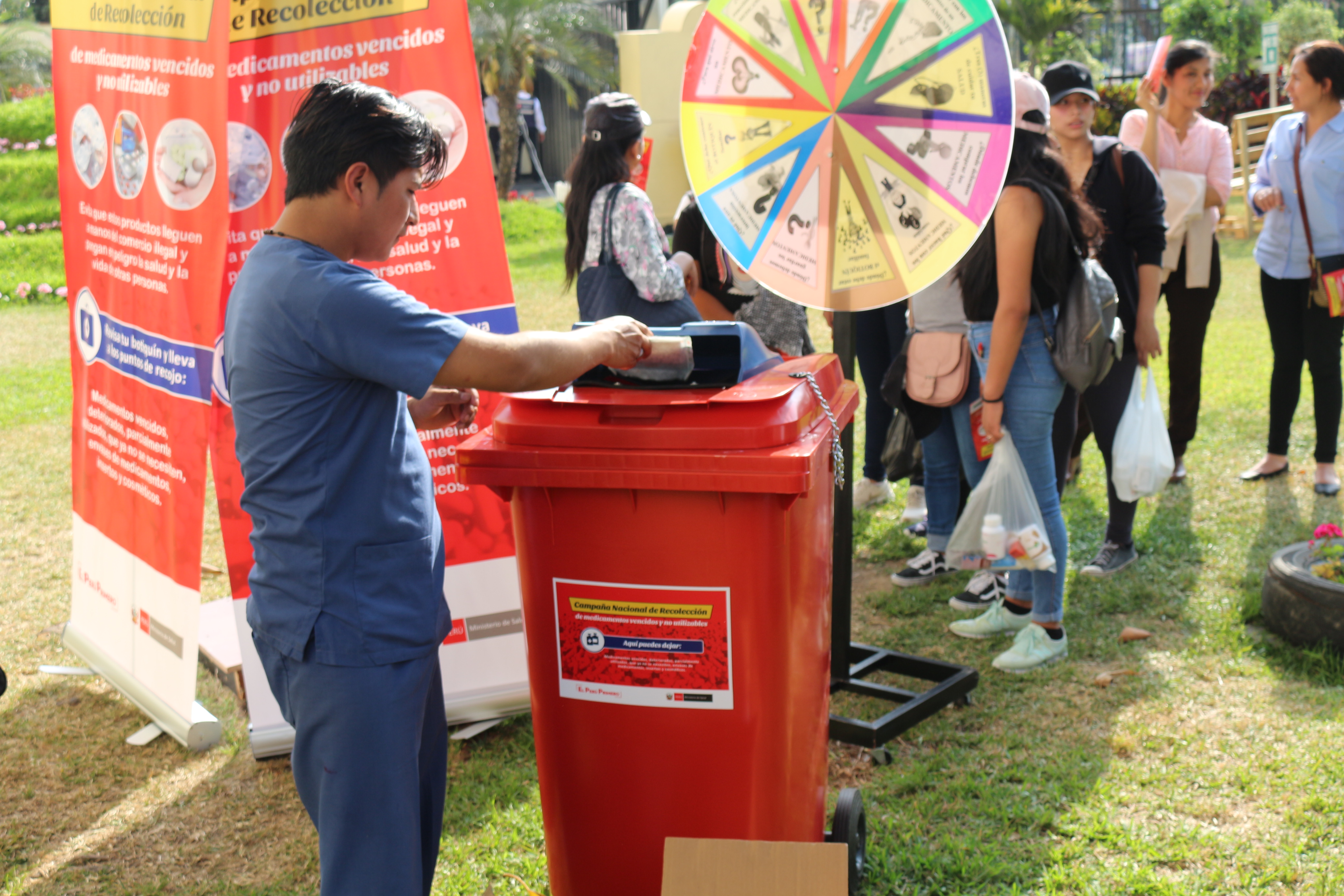 En la imagen aparece un joven depositando un medicamento vencido en el contenedor