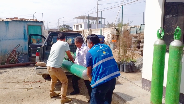 Personal edil trasladando balones de oxígeno medicinal 