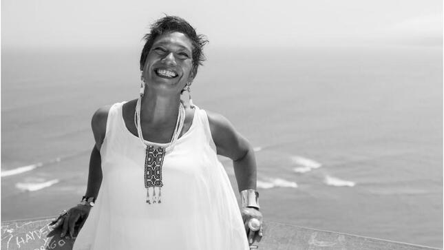 Foto de la artista Victoria en blanco y negro con el mar de fondo.