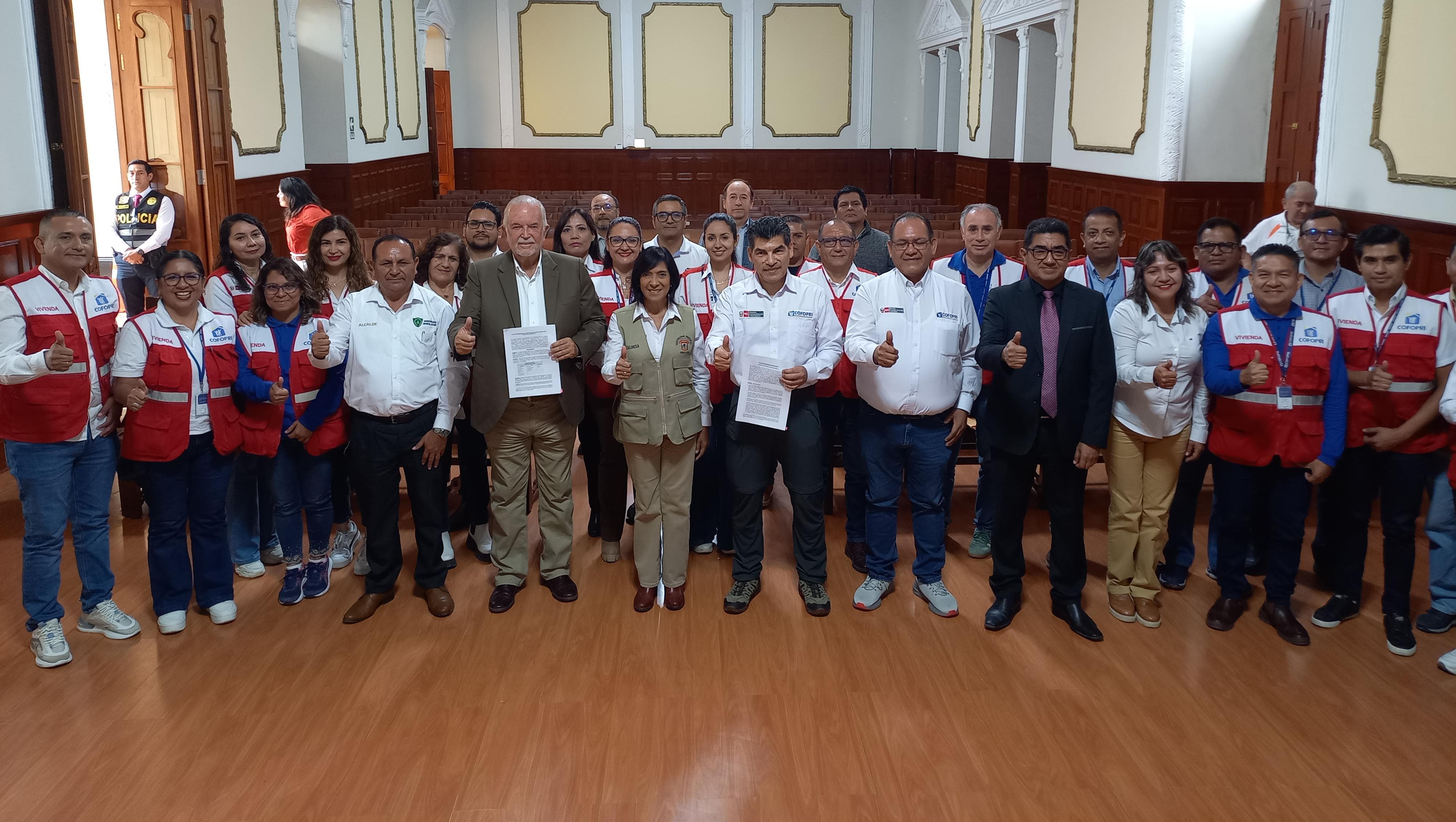 foto oficial de la firma de actas de transferencia de terrenos para titulación...
